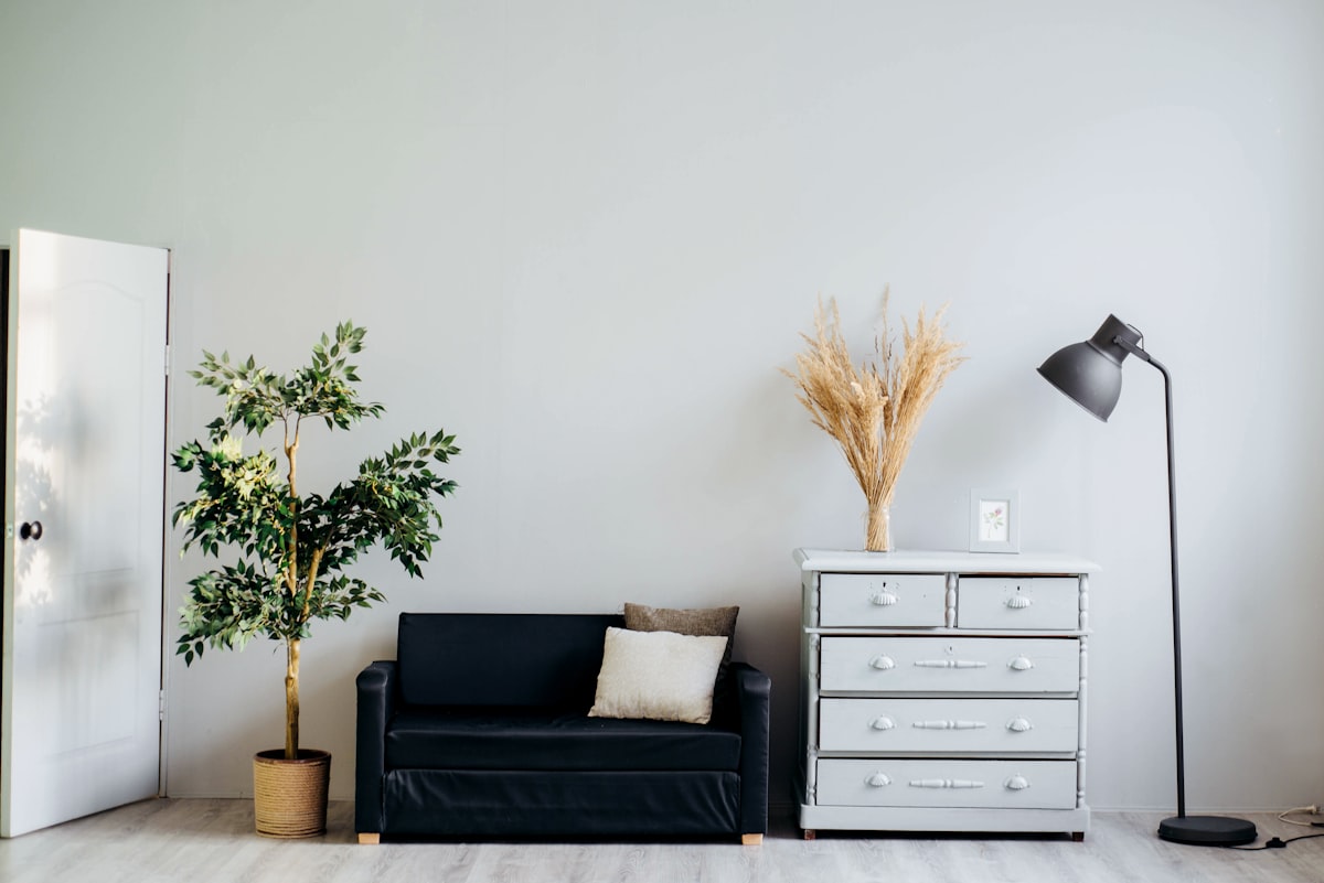 Clean beige minimalist living room corner with a textured armchair, neutral earth tones, modern interior, no human